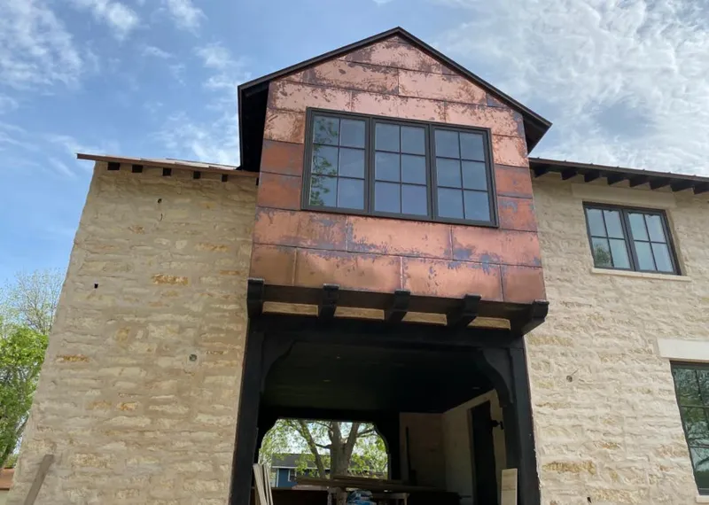Copper metal panel facade on a stone building for Skylight Installation in Briar Chapel